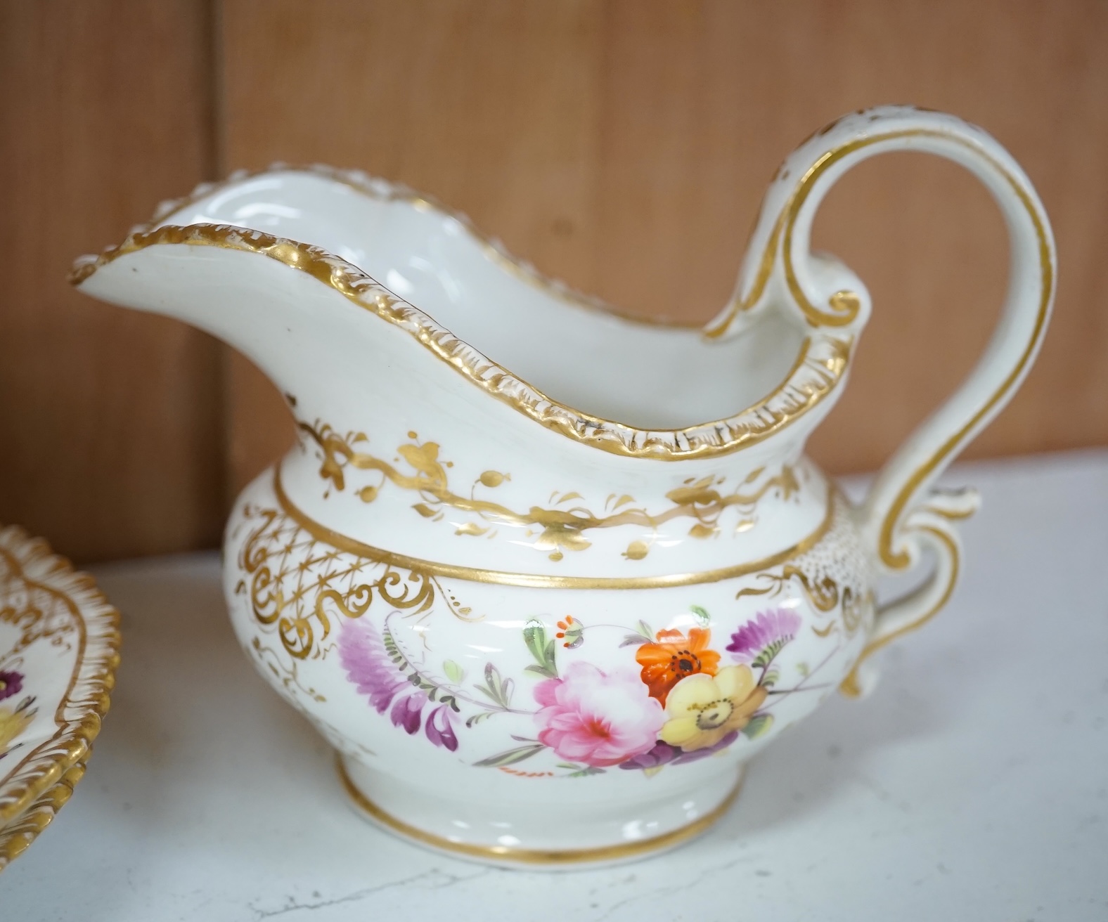 A Coalport floral part teaset, c.1825, to include teapot, sandwich plates and cups & saucers. Condition - poor to fair